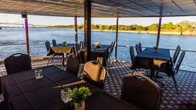 Indoor room with tables overlooking the St. Lawrence River.