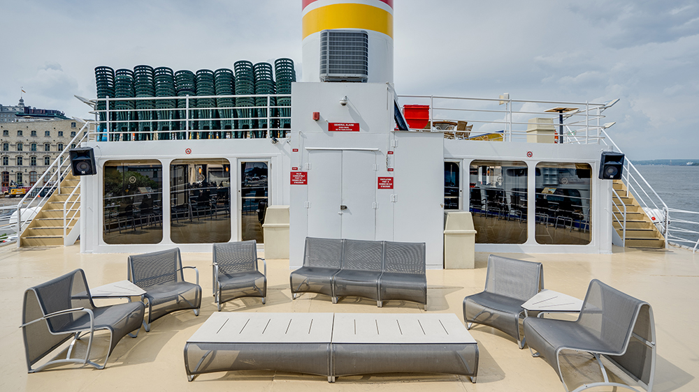  Upper deck outdoor terrace of the AML Louis Jolliet ship in Quebec, with comfortable seating available for customers