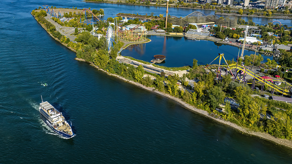 Aerial view of the AML Cavalier Maxim sailing past La Ronde in Montreal by day.
