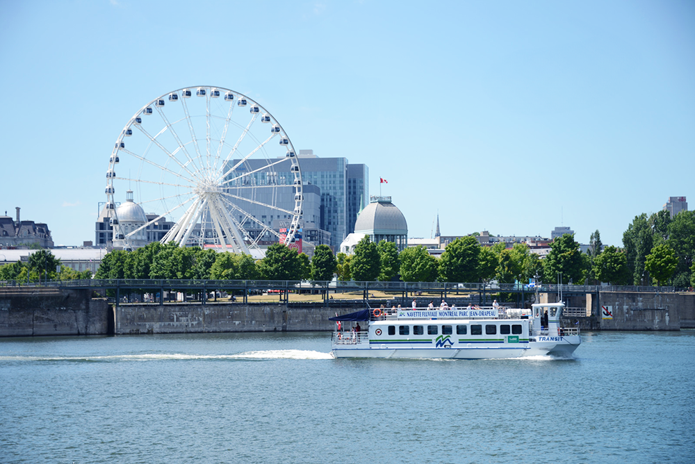 The river shuttle on the St. Lawrence with Montreal's Ferris wheel in the background.