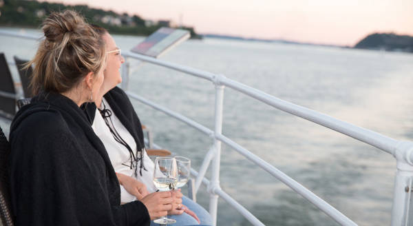 Friends taking a drink on the terrace of the AML Louis Jolliet