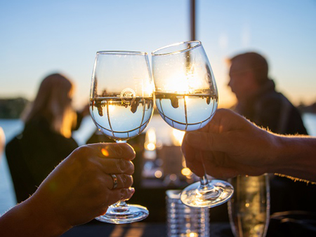 Cheers with wine at sunset