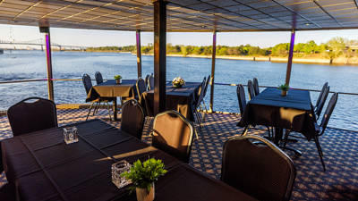  Indoor room with tables overlooking the St. Lawrence River.