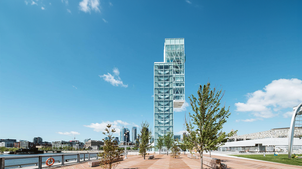 Tour du Port de Montréal avec en premier plan une esplanade arborée et en arrière plan des immeubles de Montréal