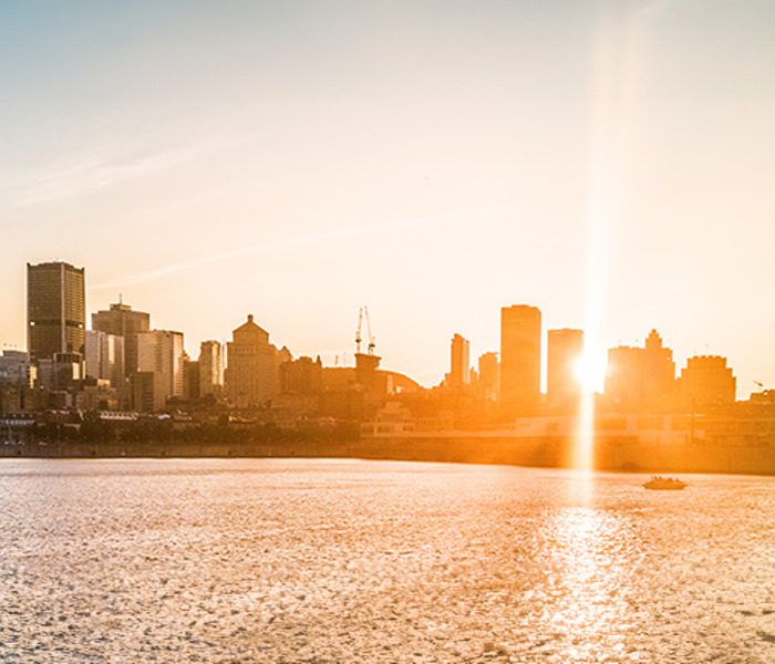 A sunset casting a warm glow on the skyline of Montreal.