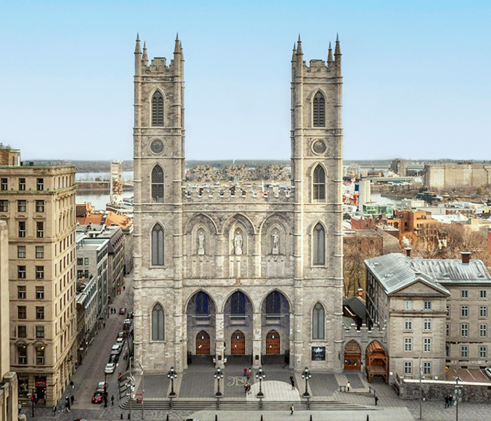 Notre-Dame Basilica of Montreal with Place d'Armes in the foreground and some Montreal buildings