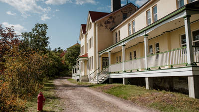 Exterior buildings of the Grosse-Île quarantine station with path and greenery
