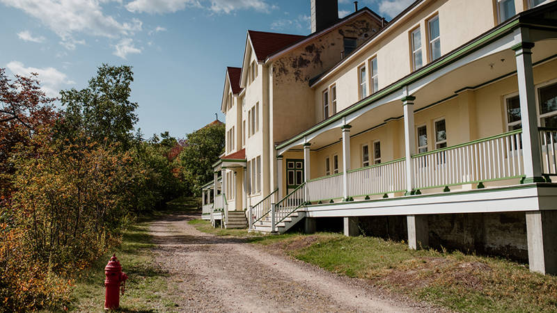 Exterior buildings of the Grosse-Île quarantine station with path and greenery