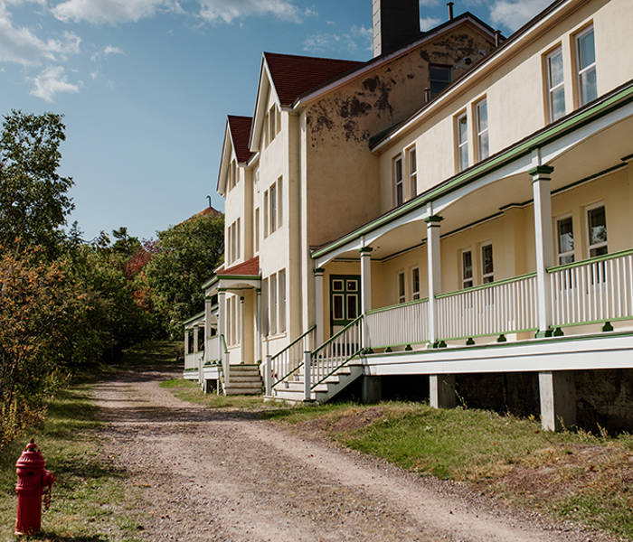 Exterior buildings of the Grosse-Île quarantine station with path and greenery