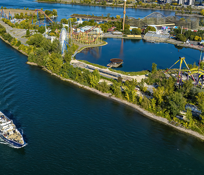 Aerial view of the AML Cavalier Maxim sailing past La Ronde in Montreal by day.