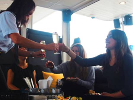 Girls doing a "Cheers!" in the VIP Lounge